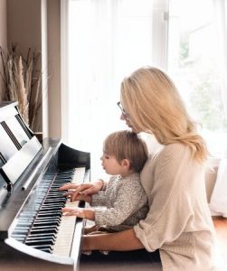 The World of Online Music Classes - mother and child play the piano together