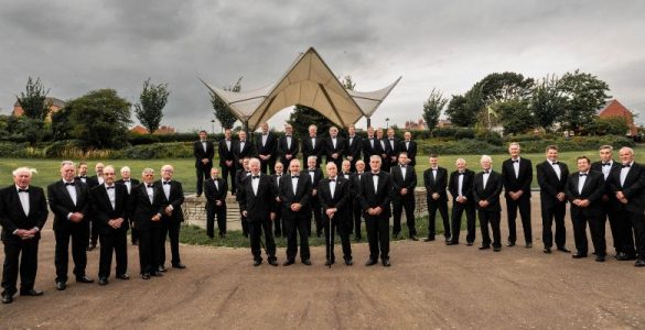 Wrexham's Rhos Male Voice Choir standing in front of Ponciau bandstand