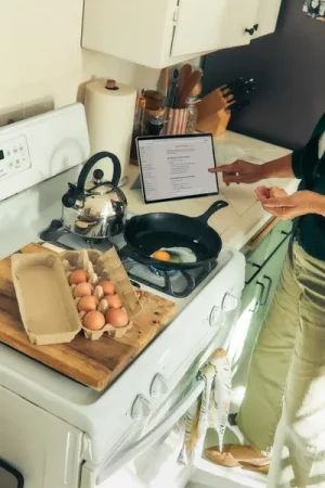 Person using tablet to help with cooking - Creating a Home Away From Home at University