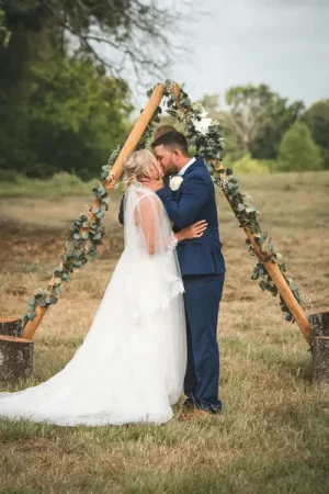 Couple kissing on their wedding day - How to Cut the Costs of a Wedding