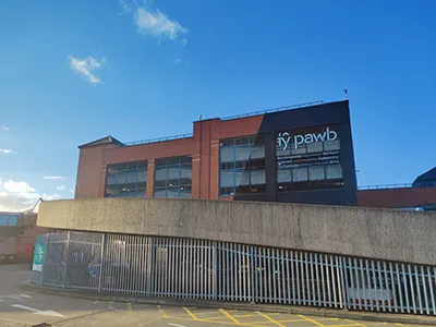 Exterior view of Tŷ Pawb building in Wrexham showing the Markets, Community and Arts signage