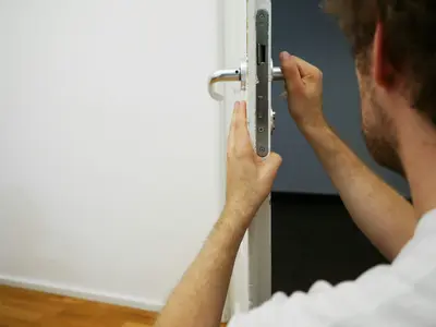 Locksmith works on door mechanism - Common Situations When People Need a Locksmith