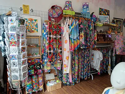 Creu shop interior showing some cards, dresses, lampshades, t-shirts, paintings and other products