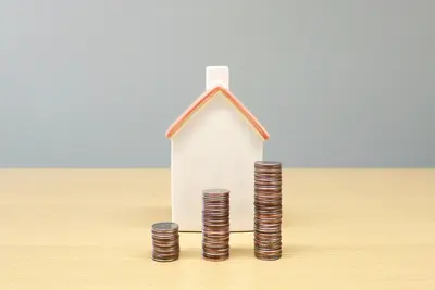 AI-generated image of piles of coins in front of a house - Beating the Odds of Rising Prices: Future-proofing Our Homes and Mindset
