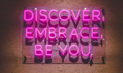 neon sign announces Discover, Embrace, Be You - Embracing Your Authentic Self A Journey of Growth and Self-Discovery