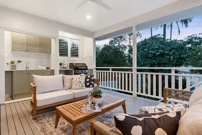 Patio with balcony and chic setee and table - Enhance Your Outdoor Living with Smart Home Updates