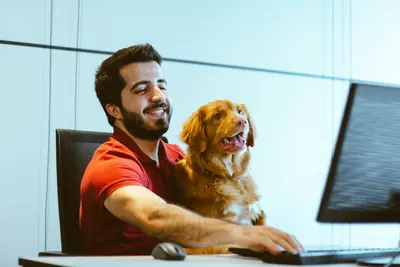 A dog and its owner look at a computer screen together - Think Before You Click: Where You Get a Pet Still Matters