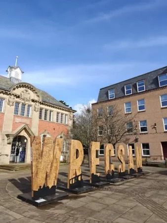 Simon O'Rourke's Wrecsam carving in Queen's Square - Wrexham BID Delivers a Cleaner, Safer City Centre