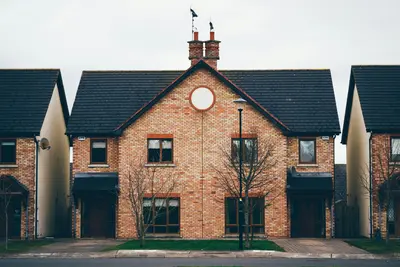Orange and blue concrete painted-house - Building Stronger Homes for a More Resilient Community