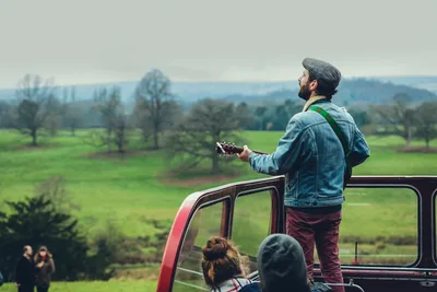 Musician playing guitar on an open-top bus in the countryside – Wrecsam2029: Inside Wrexham’s Bid to Become UK City of Culture