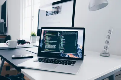 Web developer workspace with laptop and code editor - Boosting Local Businesses with Smart Solutions
