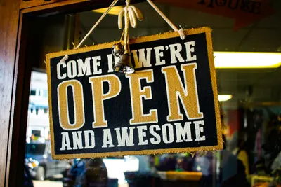 Shop open sign hanging on café door - Local Businesses Can Master Their Own Narrative