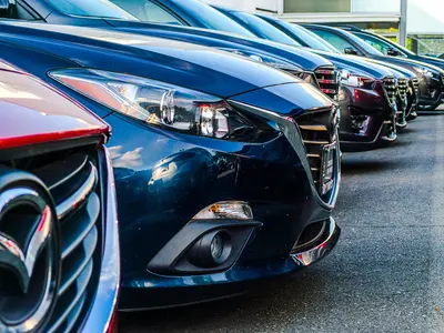 Row of used cars for sale at dealership - Why Overseas Car Purchases Are Growing