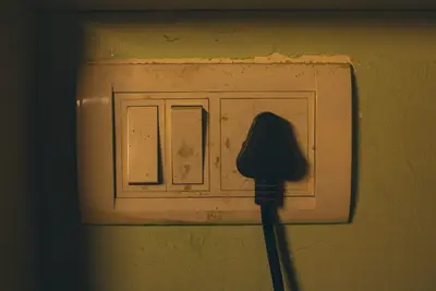 Old wall socket and light switch panel close-up - Keeping Your Home Safe: Electrical Safety Tips for Everyone