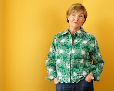 Rachel Clacher CBE against a yellow background – Rachel Clacher CBE Appointed Wrexham University Chancellor