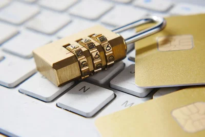 Gold Combination Padlock on a Keyboard With Payment Cards Protecting Your Business Assets: Smart Security Choices