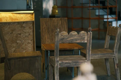 Handmade rustic chairs and a small table in distressed reclaimed wood, inspiration for DIY scaffold board furniture - The Scaffold-Board DIY Hack Taking British Homes By Storm