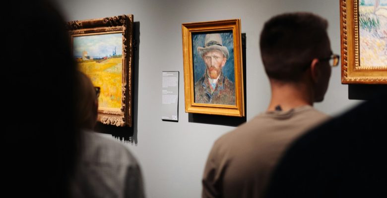 Visitors looking at paintings in an art gallery