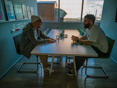 Two men sitting side by side in conversation – Wrexham to Host the First National Conversation on Male Suicide