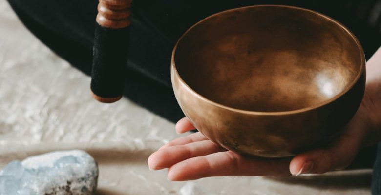 A singing bowl with sage and crystals